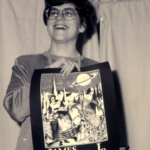 Maureen McHugh with poster designed by Freddie Baer (Tiptree T-Shirt, year 2)
