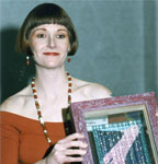 Rose Cain holding beaded Quilt award