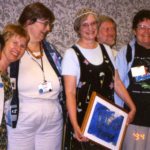 (Left to right) Ellen Klages, Pat Murphy, Jeanne Gomoll, Molly Gloss (wearing the tiara and holding the framed caligraphy piece made by Jae Adams), Eric Lindsay, Jean Weber, Karen Fowler.