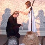 John Kessel encourages his daughter to transfer the tiara from the previous winner (Kessel) to the 2003 winner, Matt Ruff, who then bows to receive this honor. Photo by Michael Ward